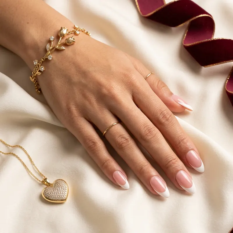 Model wrist wearing 18k tulip bracelet and salon nails